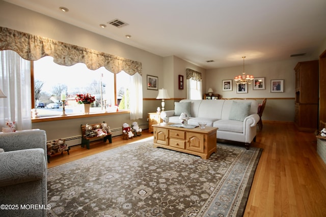 living room featuring hardwood / wood-style flooring and a notable chandelier