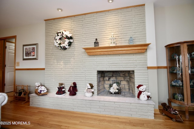 interior details with a fireplace and wood-type flooring