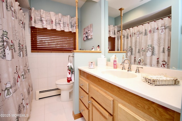 bathroom with tile patterned floors, toilet, tile walls, vanity, and a baseboard heating unit