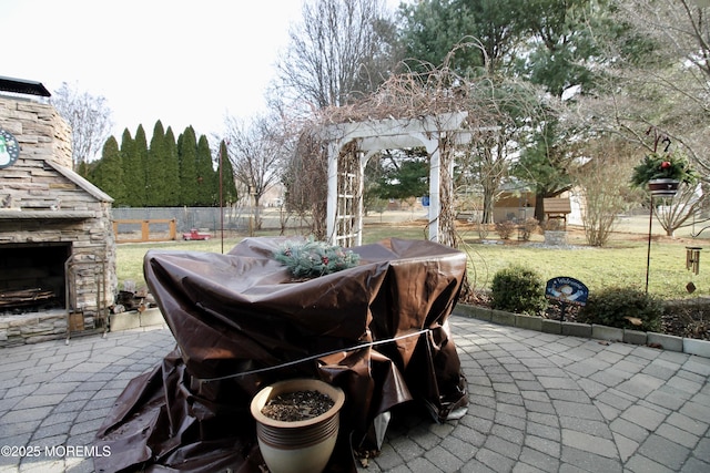 view of patio featuring an outdoor stone fireplace