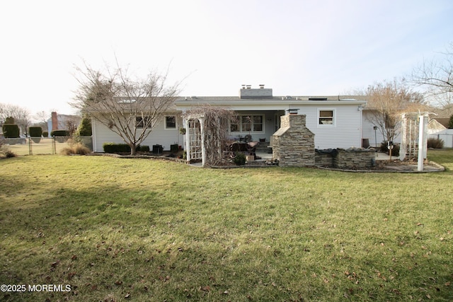 back of house with a lawn