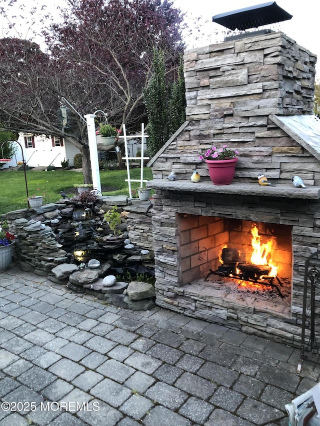 view of patio / terrace with an outdoor fireplace