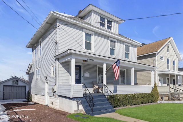 view of front of home with a garage, an outdoor structure, a front yard, and covered porch