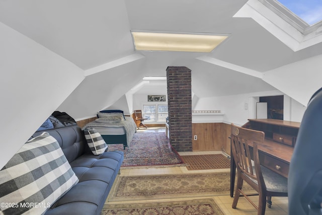 living room with lofted ceiling with skylight and wood walls