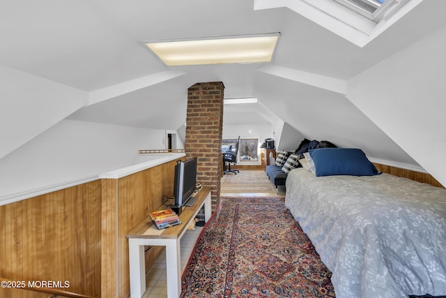 bedroom with lofted ceiling with skylight