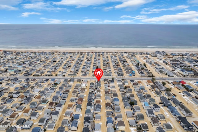 drone / aerial view featuring a view of the beach and a water view