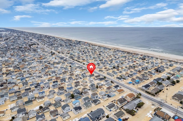 birds eye view of property with a water view and a view of the beach