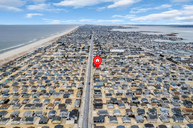 bird's eye view with a water view and a view of the beach