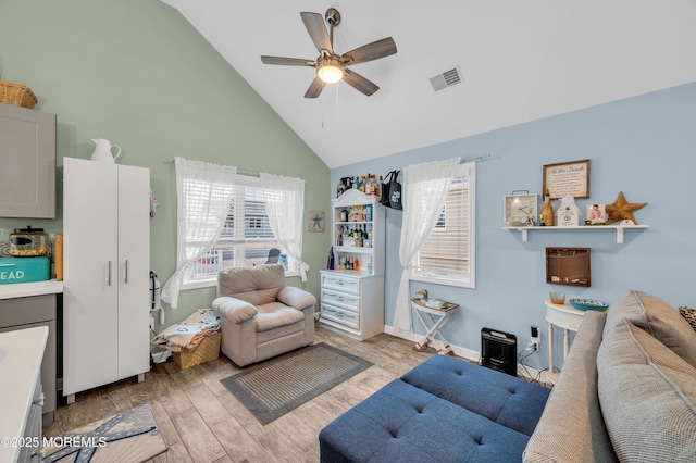 living room with ceiling fan, plenty of natural light, and high vaulted ceiling