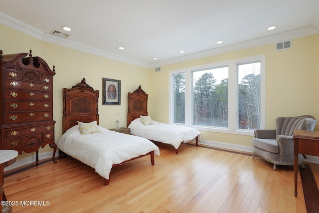 bedroom featuring crown molding and light hardwood / wood-style flooring