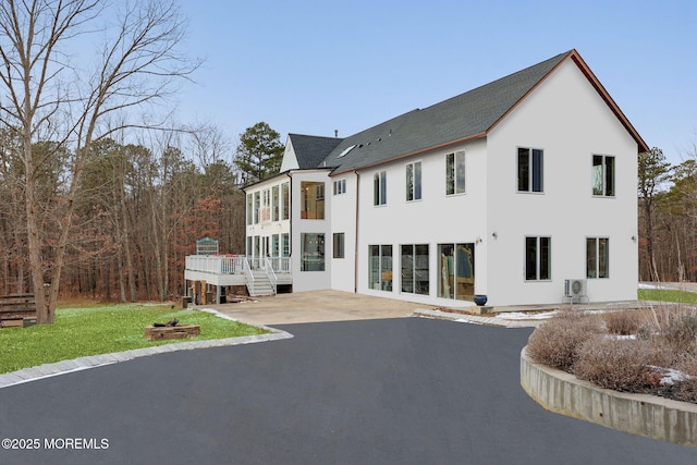 view of front of home with a sunroom and a patio area