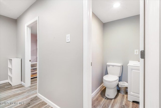 bathroom with wood-type flooring and toilet