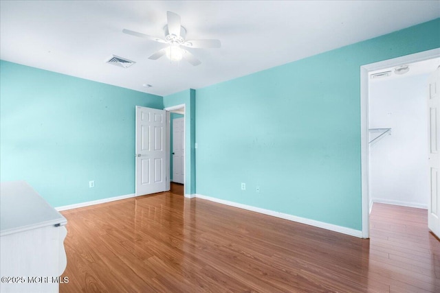 empty room featuring hardwood / wood-style floors and ceiling fan