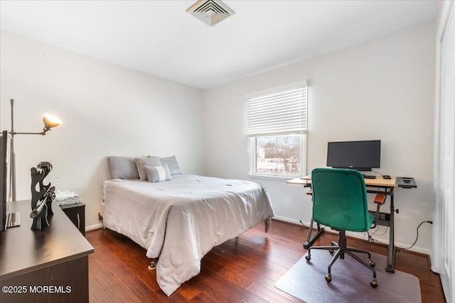 bedroom featuring dark hardwood / wood-style flooring