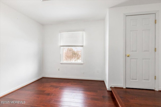 empty room featuring dark hardwood / wood-style flooring