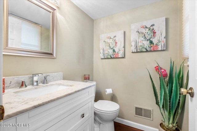 bathroom with vanity, wood-type flooring, and toilet