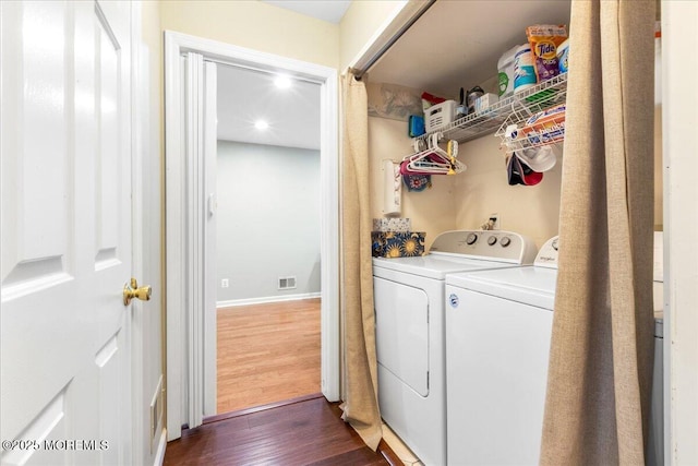 laundry area featuring dark hardwood / wood-style floors and independent washer and dryer