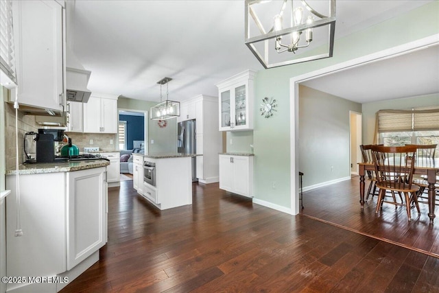 kitchen with white cabinetry, a notable chandelier, decorative light fixtures, and a kitchen island