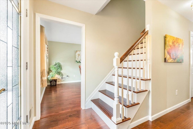 staircase featuring hardwood / wood-style flooring