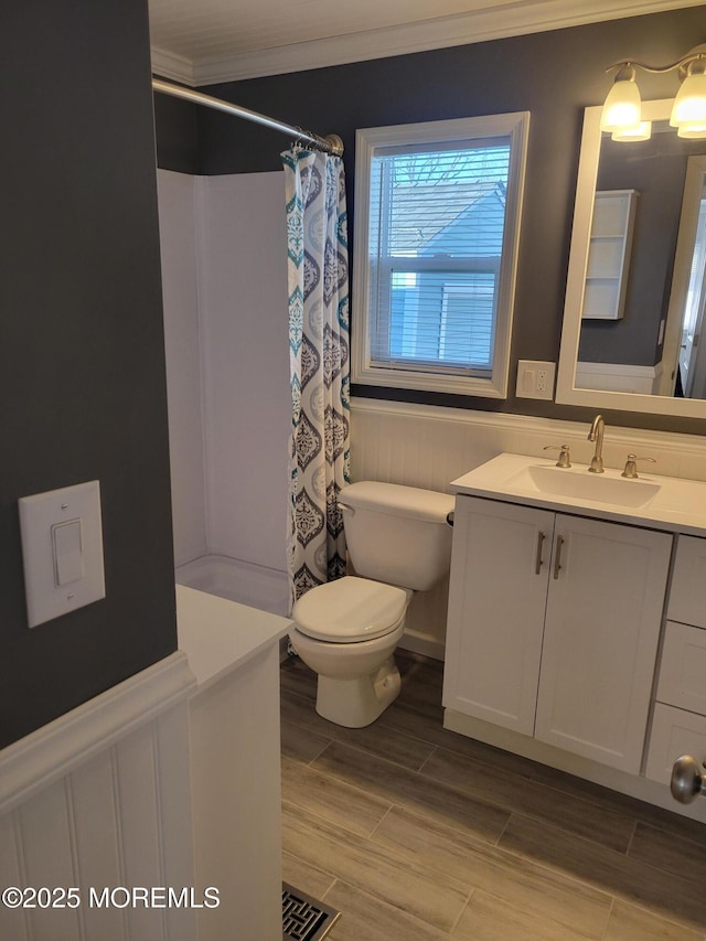 bathroom featuring vanity, curtained shower, ornamental molding, and toilet