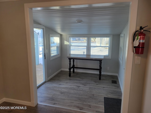 dining space featuring lofted ceiling and hardwood / wood-style floors