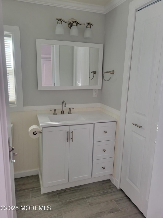 bathroom featuring crown molding and vanity