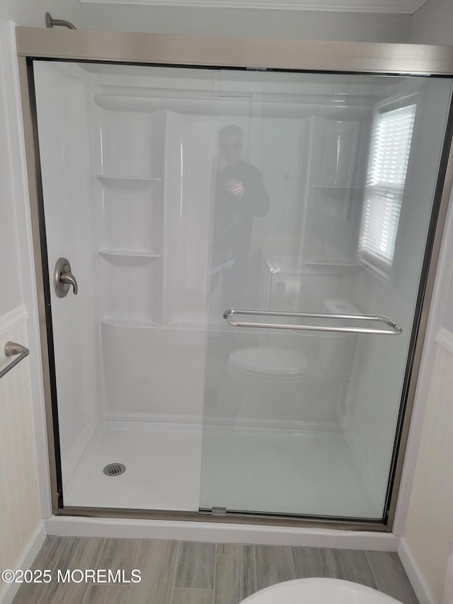 bathroom with a shower with door