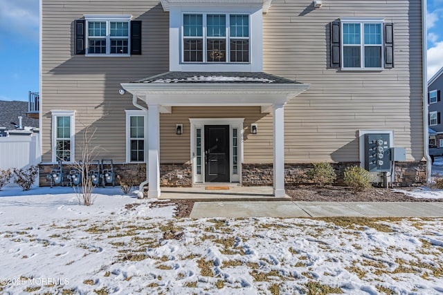 view of snow covered property entrance