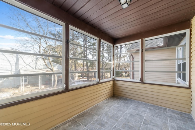 unfurnished sunroom featuring wooden ceiling