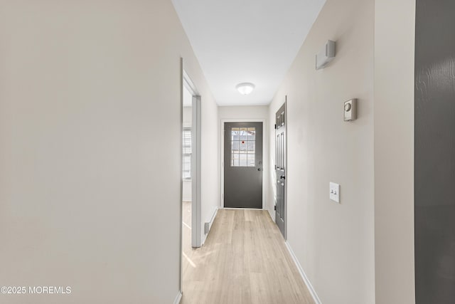 hall with light hardwood / wood-style flooring