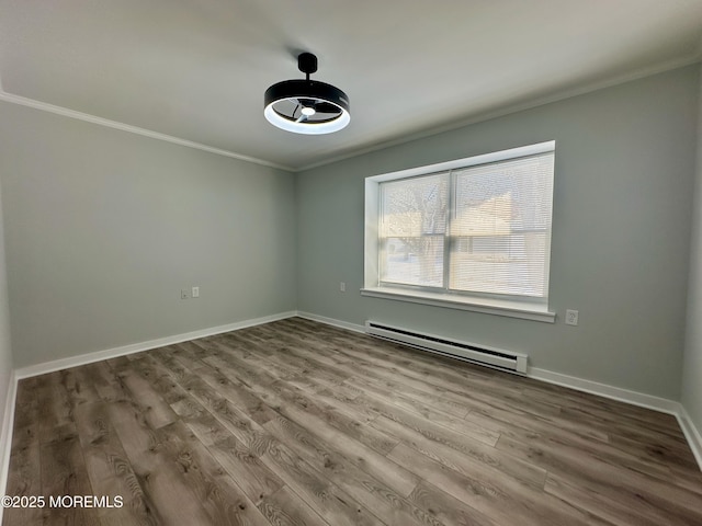 unfurnished room featuring hardwood / wood-style flooring, ornamental molding, and baseboard heating