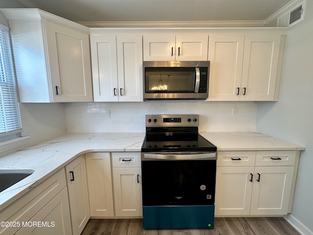 kitchen featuring appliances with stainless steel finishes and white cabinets