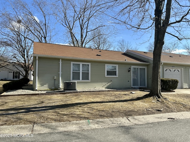 view of front of home featuring a garage and central AC unit