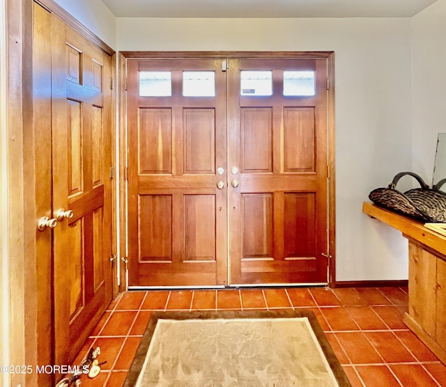 doorway featuring dark tile patterned flooring