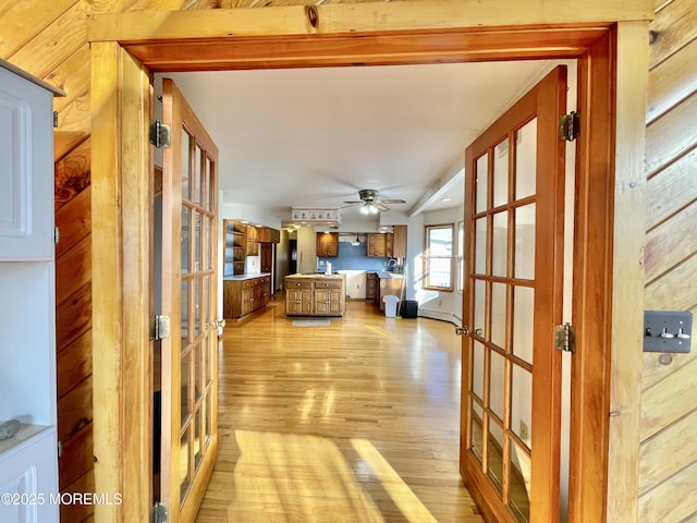 hallway featuring light hardwood / wood-style floors and french doors