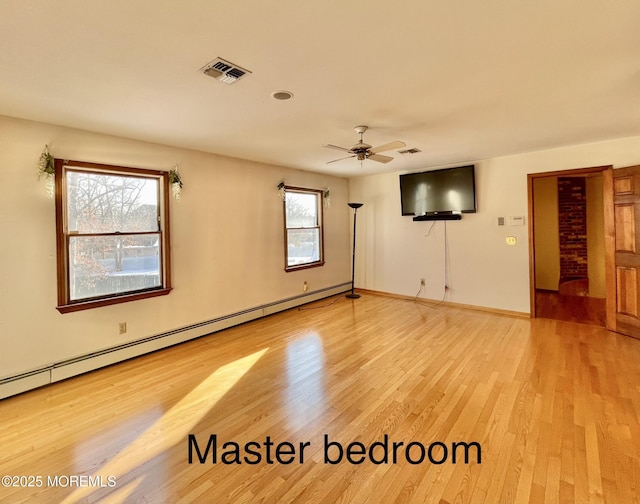 unfurnished room with hardwood / wood-style floors, ceiling fan, and a baseboard heating unit