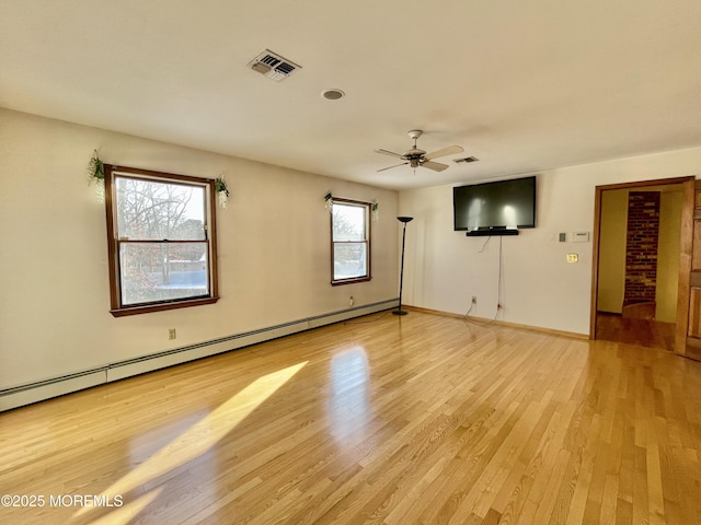 unfurnished room with ceiling fan, light hardwood / wood-style floors, a healthy amount of sunlight, and baseboard heating