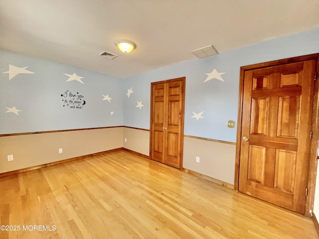 spare room with light hardwood / wood-style flooring