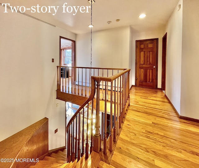 hallway with a baseboard radiator and light hardwood / wood-style floors