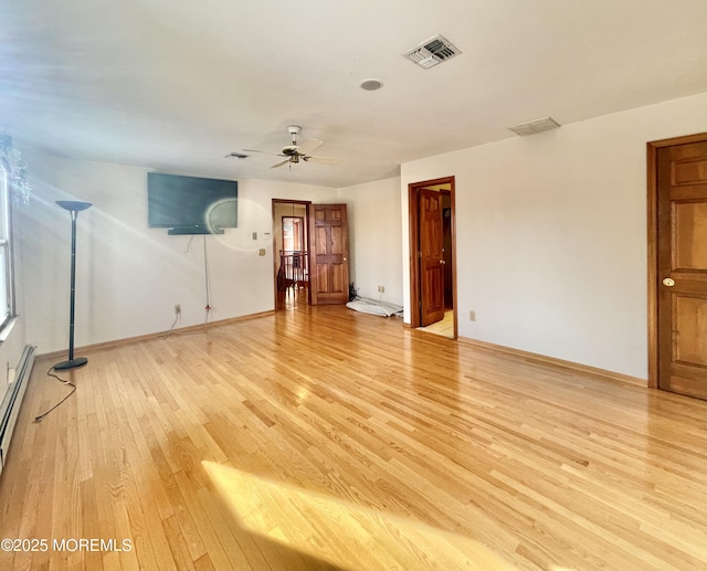 spare room with ceiling fan and light wood-type flooring