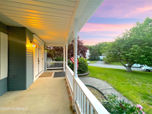 705 Princeton Rd, Lanoka Harbor, NJ 08734 - patio terrace at dusk with a porch, a lawn, and french doors
