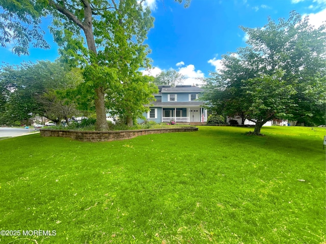 705 Princeton Rd, Lanoka Harbor, NJ 08734 - view of green lawn featuring a porch