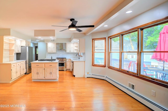 705 Princeton Rd, Lanoka Harbor, NJ 08734 - kitchen featuring appliances with stainless steel finishes, a sink, wall chimney range hood, light countertops, and backsplash