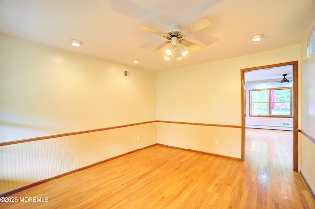 705 Princeton Rd, Lanoka Harbor, NJ 08734 - empty room with wood finished floors, a ceiling fan, baseboard heating, and baseboards