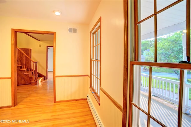 705 Princeton Rd, Lanoka Harbor, NJ 08734 - hall with light wood finished floors, stairway, healthy amount of natural light, a wainscoted wall, and baseboard heating