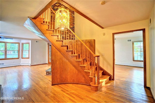 705 Princeton Rd, Lanoka Harbor, NJ 08734 - staircase with wood finished floors, a baseboard radiator, baseboards, and a chandelier
