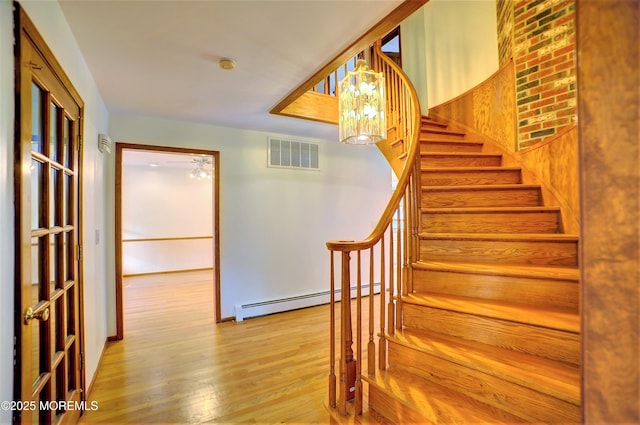 705 Princeton Rd, Lanoka Harbor, NJ 08734 - staircase with baseboard heating, wood finished floors, baseboards, and a chandelier