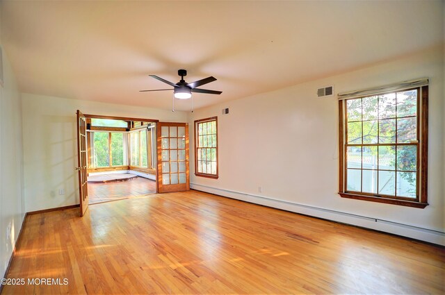 705 Princeton Rd, Lanoka Harbor, NJ 08734 - empty room with baseboard heating, light wood-style floors, ceiling fan, and baseboards