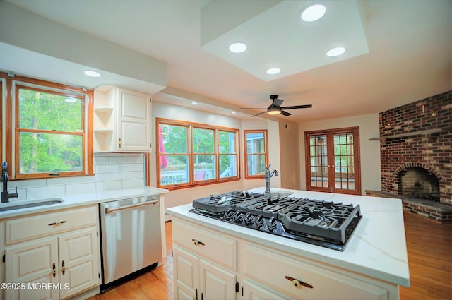 705 Princeton Rd, Lanoka Harbor, NJ 08734 - kitchen with dishwasher, black gas stovetop, ceiling fan, light wood finished floors, and a sink