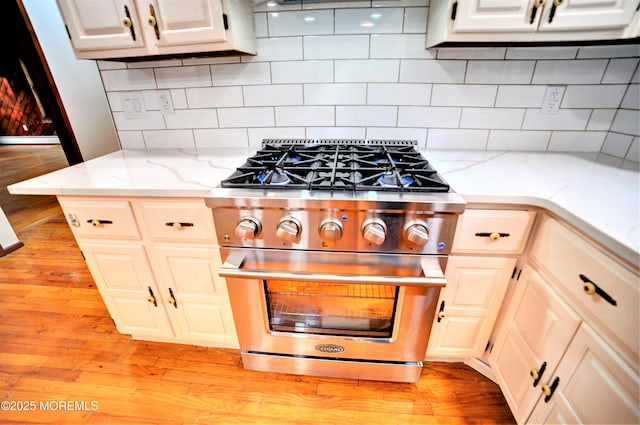 705 Princeton Rd, Lanoka Harbor, NJ 08734 - kitchen featuring high end range, backsplash, light wood-style flooring, and light stone counters